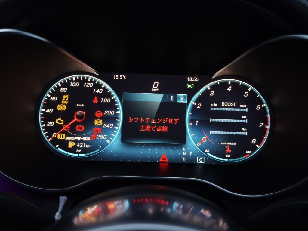 MVIMG_20260522_185516 – mbFAST Tuning Close-up of a car's illuminated digital instrument cluster with speedometer, tachometer, and warning icons in a dark cabin.