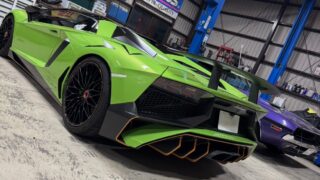1776432895834 – mbFAST Tuning Bright green Lamborghini Aventador in a workshop with a blue car lift and tools in the background.