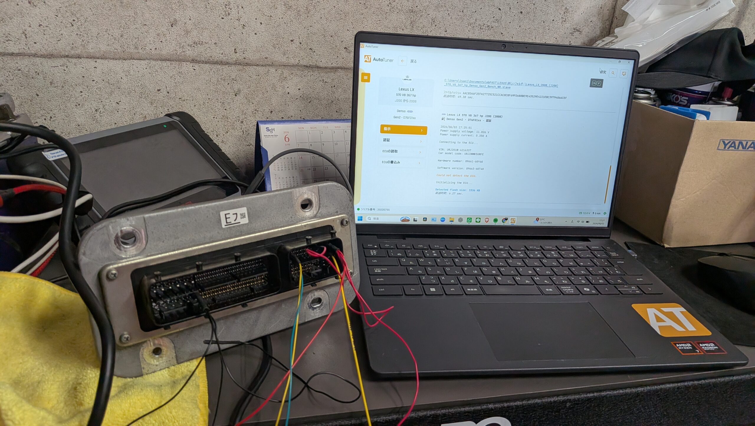 PXL_20260603_082745435 – mbFAST Tuning Laptop displaying AutoTuner software on a workshop bench with exposed wiring and a torn ECU harness nearby on a yellow rag.
