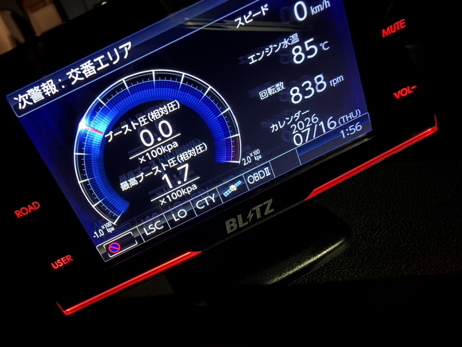 Car instrument cluster showing digital gauges: boost 0.0 kPa, speed 0 km/h, engine temp 85°C, RPM 838, date 2026/07/16 THU (BLITZ display).