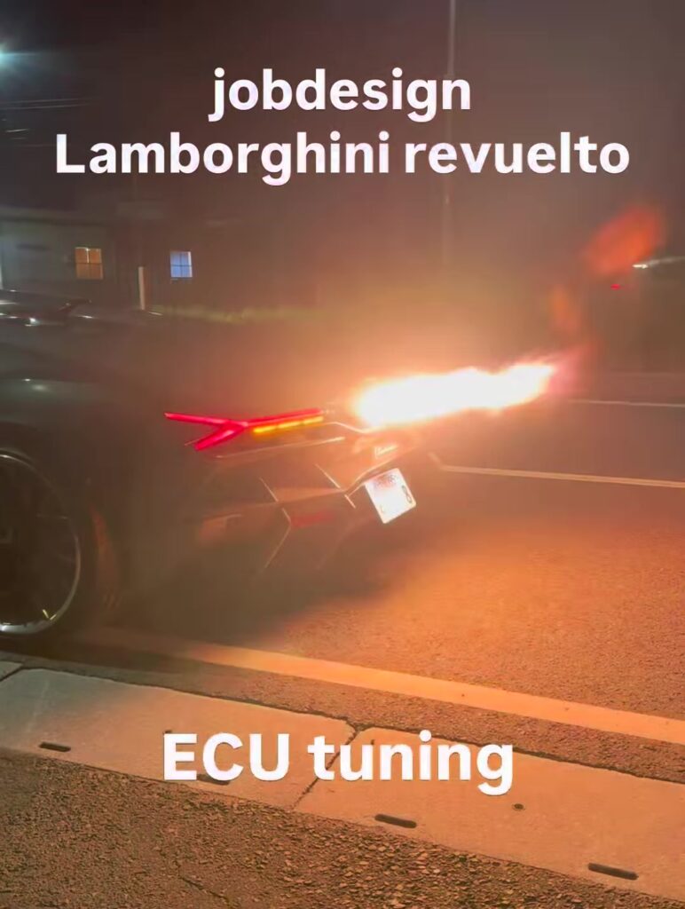 Nighttime street scene with a dark sport motorcycle spewing a bright exhaust flame; text overlays read 'jobdesign Lamborghini revuelto' and 'ECU tuning'